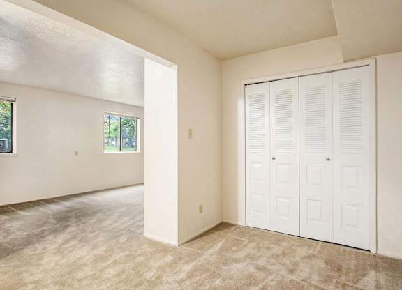 A sleeping area with a large closet at Normandy Village Apartments, Michigan City