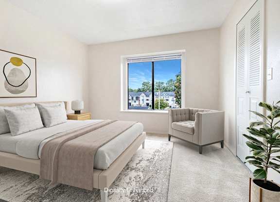 A bedroom with a large bed and a window at North Pointe Apartments, Elkhart