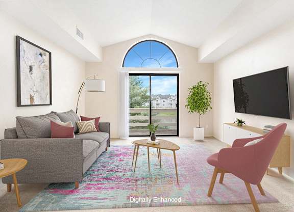 A living room with a cathedral ceiling and a slider to a balcony at North Pointe Apartments, Elkhart