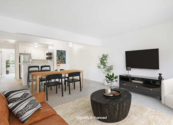 A modern living room with a wooden coffee table and a flat screen TV at North Pointe Apartments, Elkhart