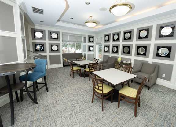 A dining room with a table surrounded by chairs and pictures on the wall  at Northport Apartments, Macomb, MI, 48044