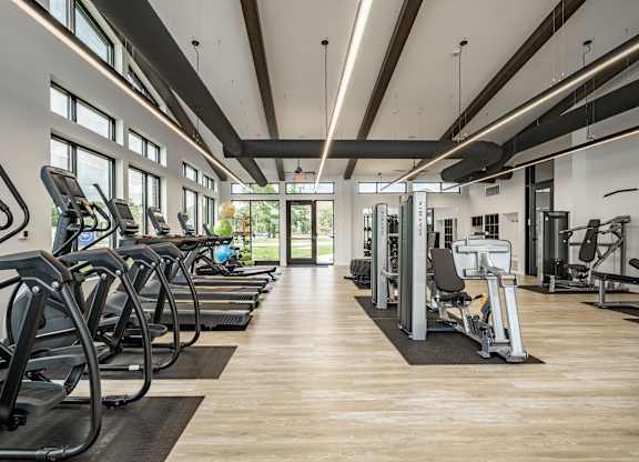 A gym with treadmills and other exercise equipment.