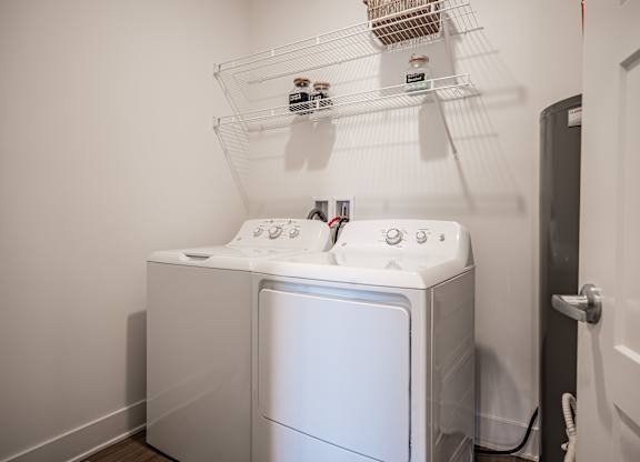 A white washing machine in a laundry room.