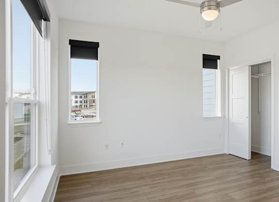 A room with a ceiling fan and a window with blinds at Nuvo Flats, Indiana, 46410