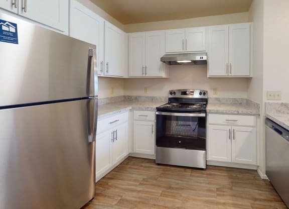 a renovated two bedroom kitchen with stainless steel appliances and white cabinets at Oak Shores Apartments, Oak Creek, Wisconsin