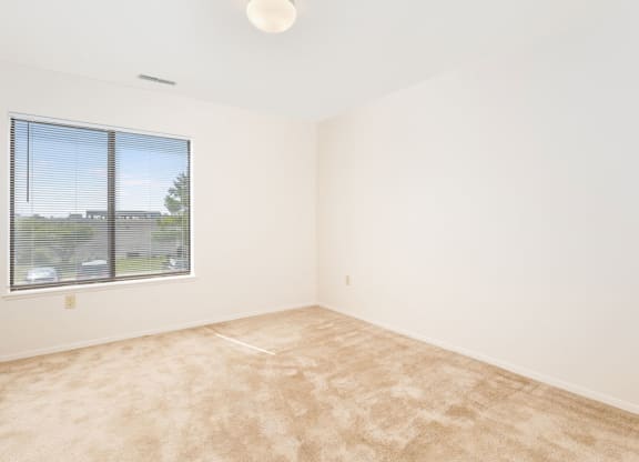 Large Bedroom with Window at Oak Shores Apartments in Oak Creek, WI