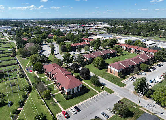 A bird's eye view of a park-like apartment community with a blue sky at Old Monterey Apartments, Springfield, MO