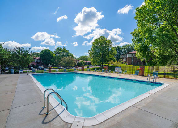 Relaxing Swimming Pool With Lounge Chairs at Old Farm Apartments, Elkhart