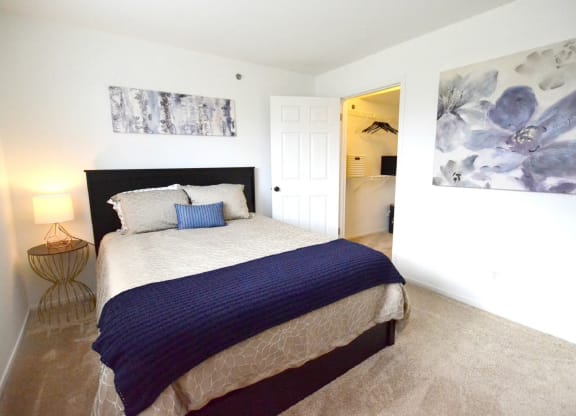 a bedroom with a bed and a nightstand at Northport Apartments, Macomb, MI, 48044
