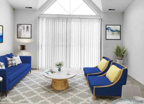 a living room with blue couches and yellow pillows  at Northport Apartments, Michigan