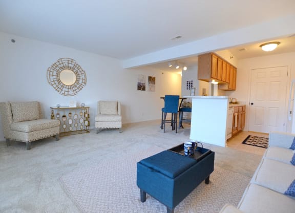a living room with a couch a chair and a table at Northport Apartments, Macomb, Michigan