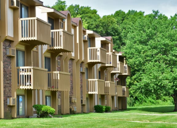 a row of apartment buildings with balconies and trees in the background at Beacon Hill and Great Oaks Apartments, Rockford, IL