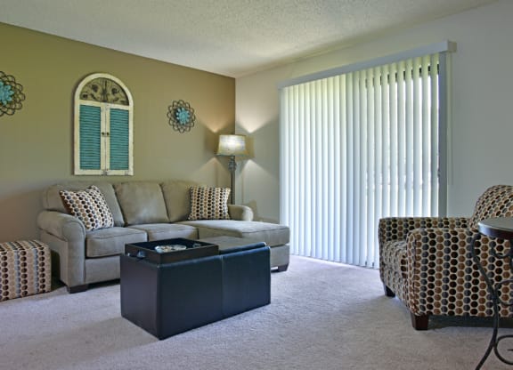 a living room with a couch chairs and a coffee table at Beacon Hill and Great Oaks Apartments, Rockford, Illinois