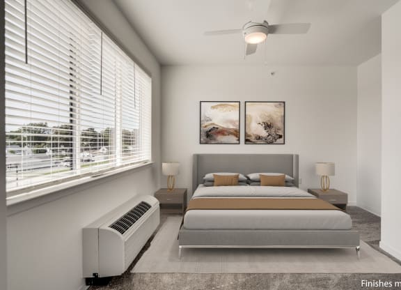 a bedroom with a bed and two windows  at Uptown Square Apartments, Troy, 48083
