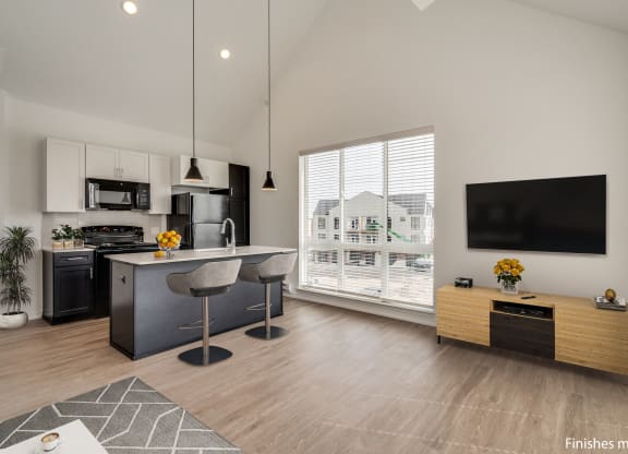 a kitchen and living room with a large window and a view of a house  at Uptown Square Apartments, Troy, MI, 48083