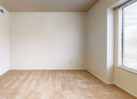 bedroom with a window and plush carpeting at Pine Knoll Apartments, Battle Creek, 49014