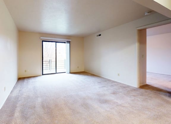 spacious living room with a door to a balcony at Pine Knoll Apartments, Battle Creek, 49014