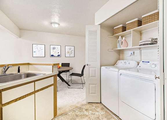 A kitchen with a washer and dryer at Pine Knoll Apartments, Battle Creek