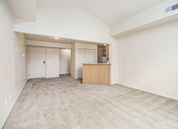 the living room with natural light from slider to balcony at Pine Knoll Apartments, Battle Creek, MI