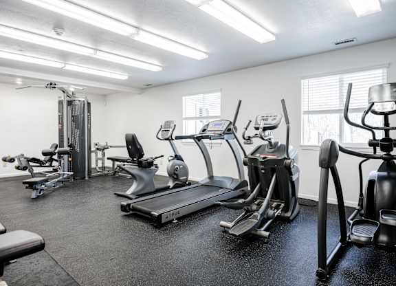 A gym with treadmills, elliptical machines, and other exercise equipment at Polo Run Apartments, Greenwood, Indiana