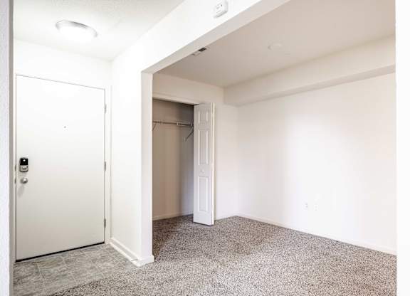 A white door is open to a carpeted room at Polo Run Apartments, Greenwood, 46142
