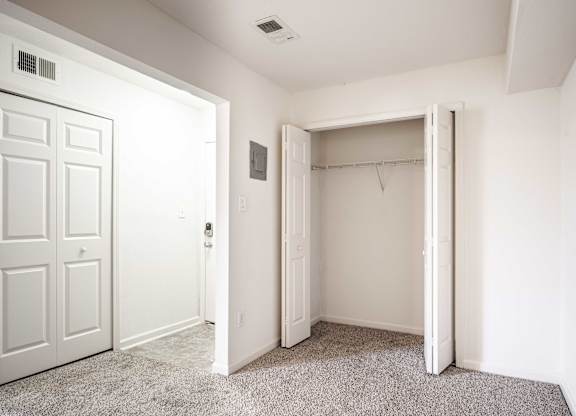 A white door is open to a room with a carpeted floor at Polo Run Apartments, Greenwood, IN, 46142