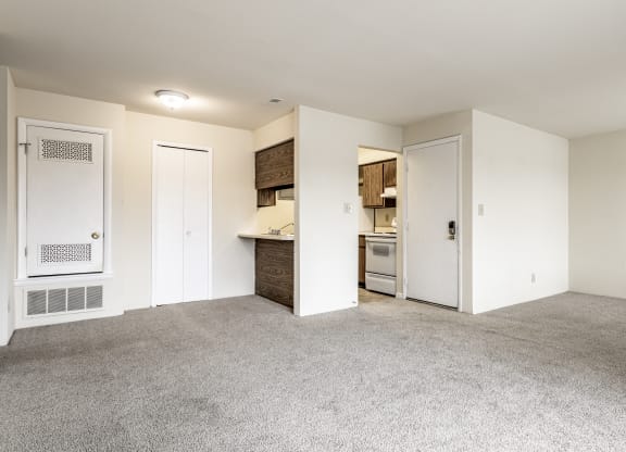 an empty living room and kitchen with white walls and carpet at Scarborough Lake Apartments, Indianapolis, Indiana, 46254