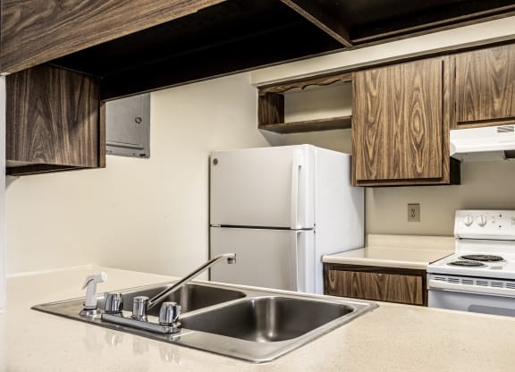 a kitchen with a sink and a stove and a refrigerator at Polo Run Apartments, Greenwood, 46142