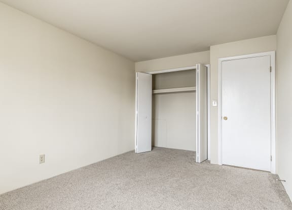 a bedroom with a closet and an open door at Scarborough Lake Apartments, Indianapolis, IN, 46254