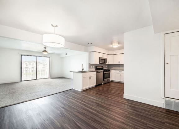 an empty kitchen and living room with a large window at Green Ridge Apartments, Grand Rapids, 49544
