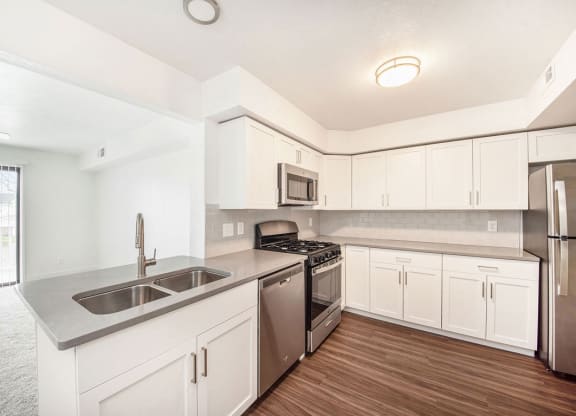 a kitchen with white cabinets and stainless steel appliances at Green Ridge Apartments, Michigan, 49544