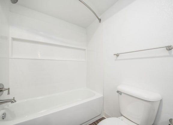 a bathroom with a toilet and a bathtub at Green Ridge Apartments, Grand Rapids, Michigan