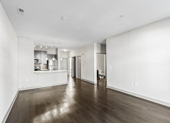 A spacious room with wooden floors and white walls. at River Crossing Apartments, Missouri, 63303
