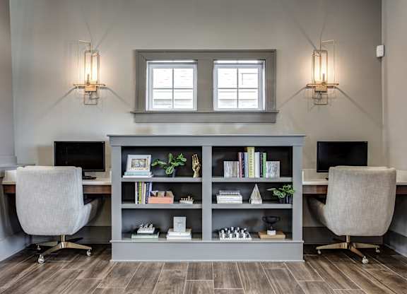 A modern home office with a desk, chair, and bookshelf. at River Crossing Apartments, St. Charles, 63303