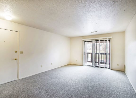 living room leading to a private balcony at Seville Apartments, Kalamazoo, MI