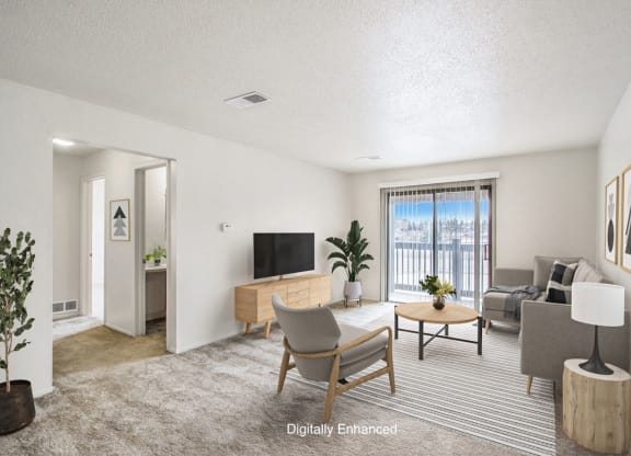 a living room with a couch and a slider to a balcony at Seville Apartments, Kalamazoo, MI, 49009