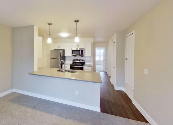 kitchen view from a living room at Signature Pointe Apartment Homes in Athens, AL