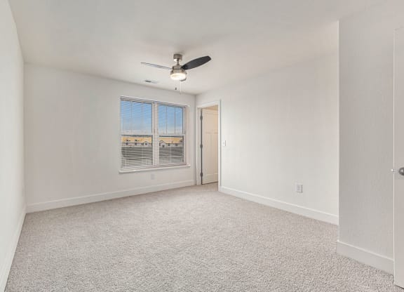 Bedroom with a walk in closet and a large window  at Signature Pointe Apartment Homes, Athens, AL, 35611