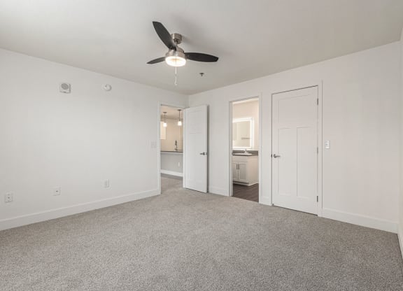 Bedroom with a ceiling fan and doors to a 2nd bathroom and closet  at Signature Pointe Apartment Homes, Athens, AL