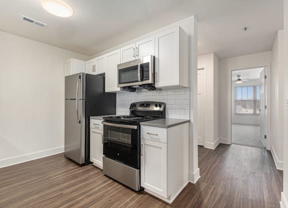 Two bedroom kitchen with white, shaker-style cabinets  at Signature Pointe Apartment Homes, Athens, AL