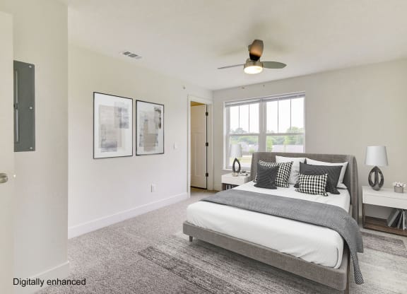 a bedroom with a large windows and a ceiling fan  at Signature Pointe Apartment Homes, Alabama, 35611
