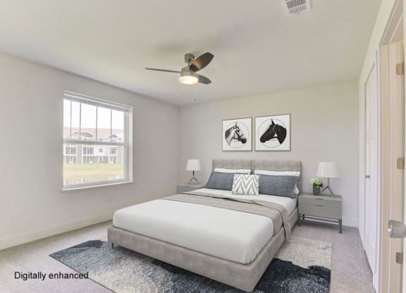 a bedroom with a bed and a ceiling fan  at Signature Pointe Apartment Homes, Alabama, 35611