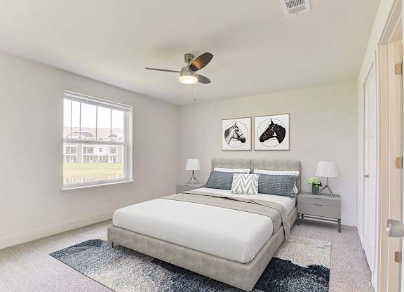 A bedroom with a bed, nightstands, a window and a ceiling fan at Signature Pointe Apartment Homes, Athens