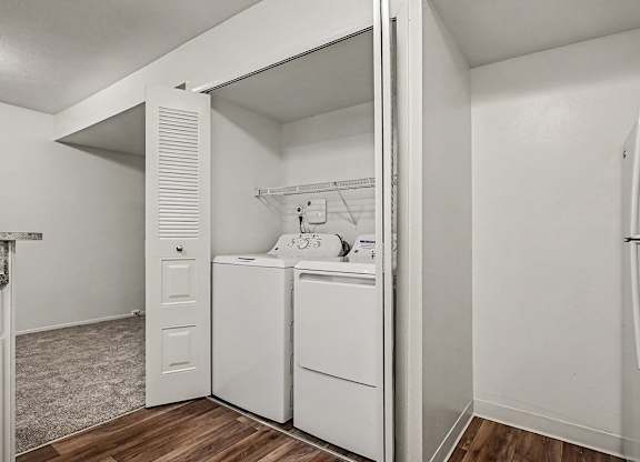 A white laundry room with a washer and dryer.