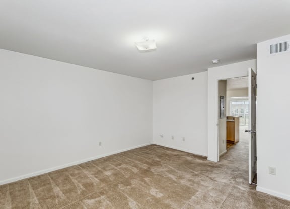 Spacious Bedroom with Plush Carpeting at Stoney Pointe Apartment Homes in Wichita, KS