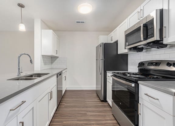 a kitchen with stainless steel appliances and white cabinets at Stoney Pointe Apartment Homes, Kansas, 67226