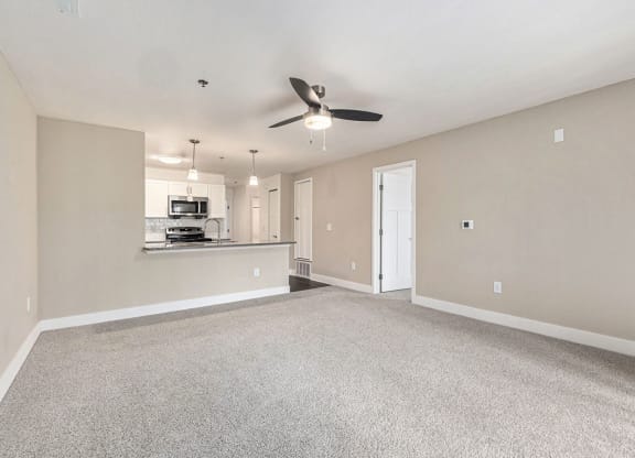 living room facing towards the kitchen with a ceiling fan at Stoney Pointe Apartment Homes, Kansas
