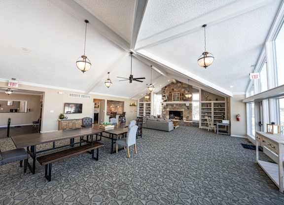 A large room with a stone floor and a fireplace.