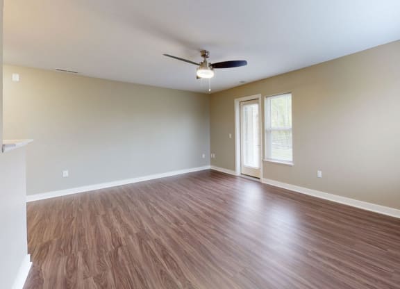 enlarged living room with extra windows and a ceiling fan at Strathmore Apartment Homes, West Des Moines, 50266