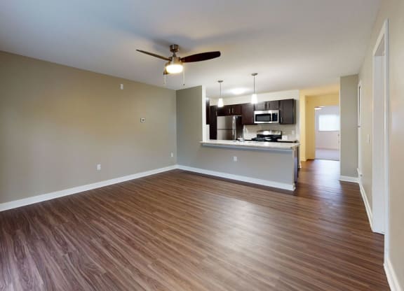 spacious living room and kitchen with hard-surface flooring at Strathmore Apartment Homes, West Des Moines, 50266